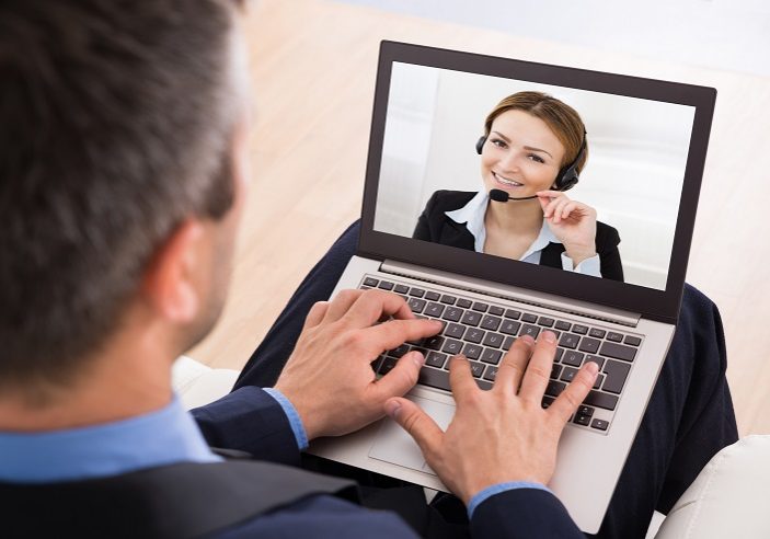 Businessman Video Chatting With Businesswoman On Laptop